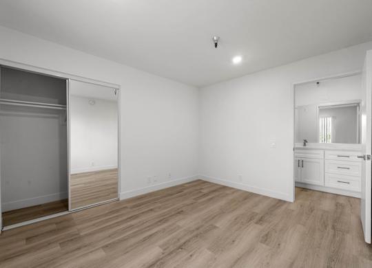A room with a sliding door and wooden flooring.