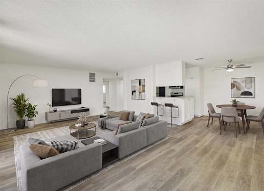 Open concept living and dining area with wood style flooring at Parc @ 5 Apartments, Downey