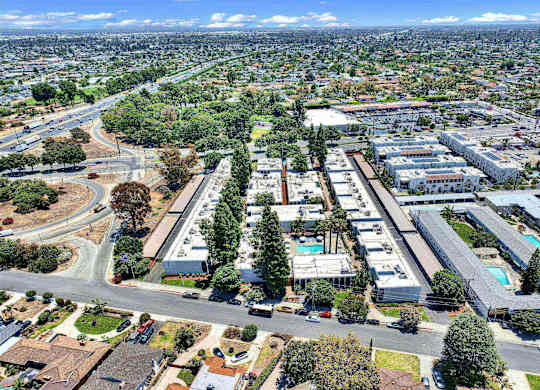 Aerial view of apartment community with landscaped grounds at Parc @ 5 Apartments, Downey, CA 90240