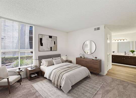 Modern bedroom with ensuite bathroom and large windows at Parc @ 5 Apartments, Downey