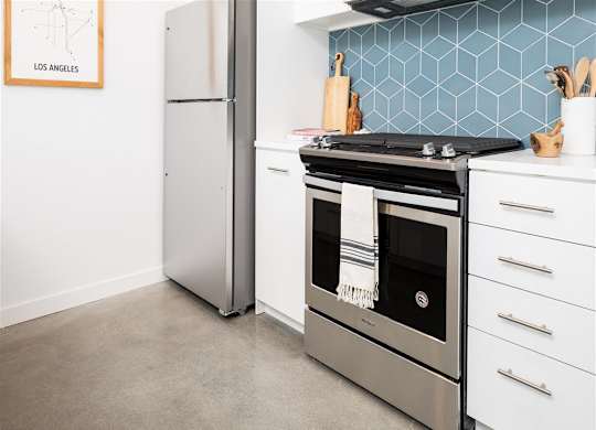 Kitchen with range and stainless refridgerator at the perch, Los Angeles, CA 90065