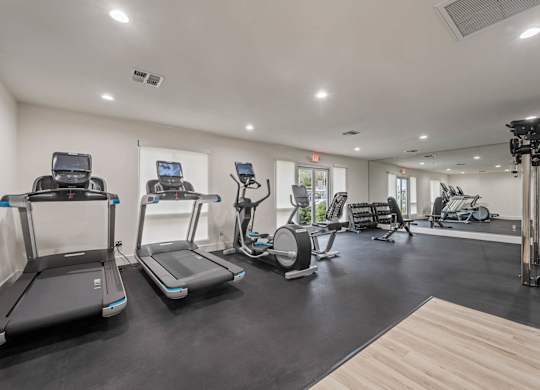 the gym is equipped with treadmills and other fitness equipment at Monterra Ridge Apartments, California,91351