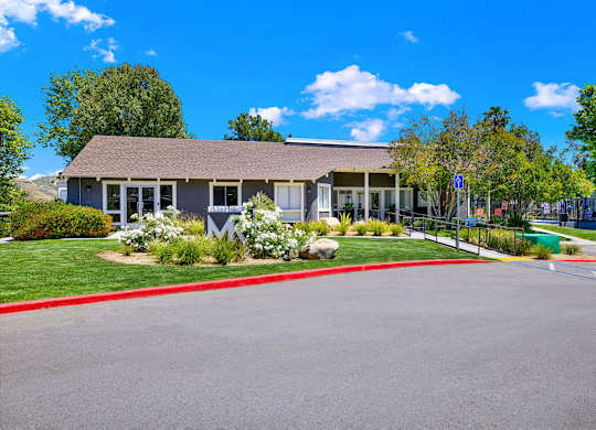 the front of a house with a driveway and a parking lot at Monterra Ridge Apartments, California,91351