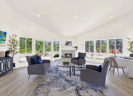 a living room with couches and chairs and a fireplace at Monterra Ridge Apartments, Canyon Country