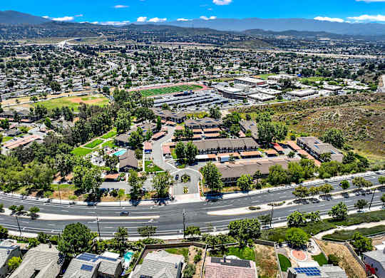 an aerial view of a parking lot with houses and trees at Monterra Ridge Apartments, California,91351