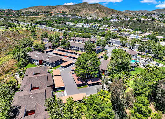 a aerial view of a neighborhood with houses and trees at Monterra Ridge Apartments, Canyon Country