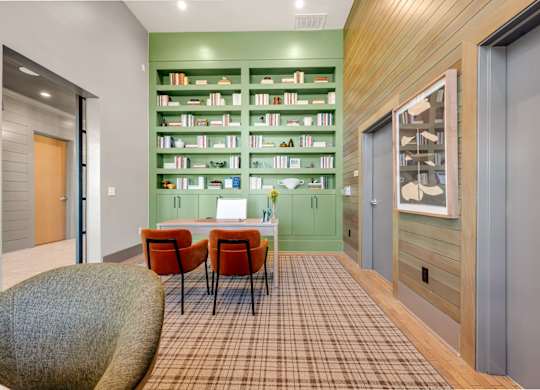 A room with a green bookshelf and a brown checkered floor.