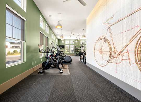 A room with a green wall and a bicycle diagram on the wall.
