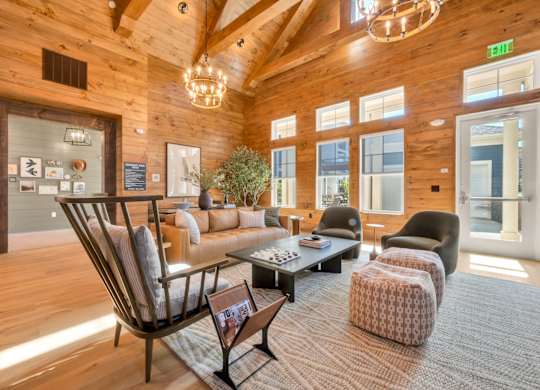 A living room with a wooden floor and a large window.
