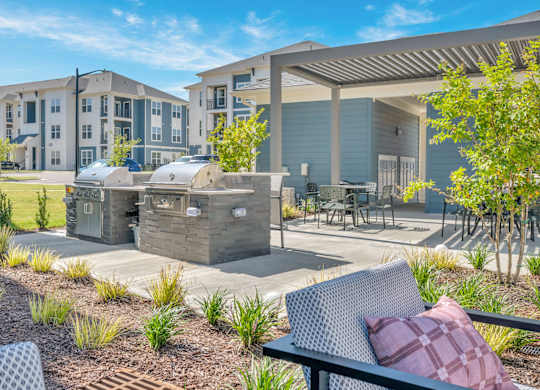 A sunny day at a residential complex with a picnic table and chairs.