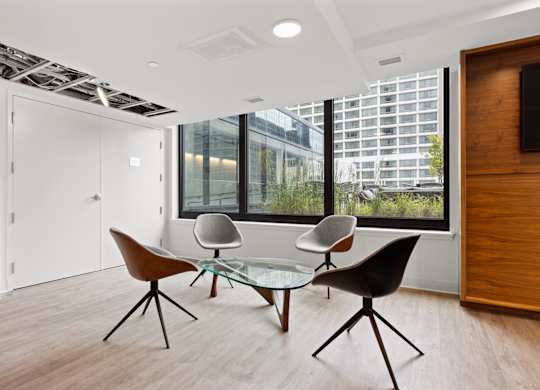 A modern room with a glass table and chairs.