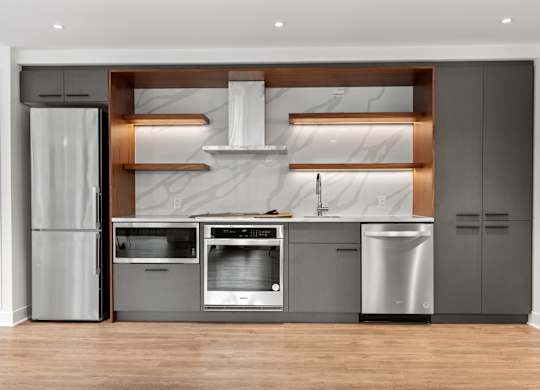 A modern kitchen with stainless steel appliances and wooden accents.