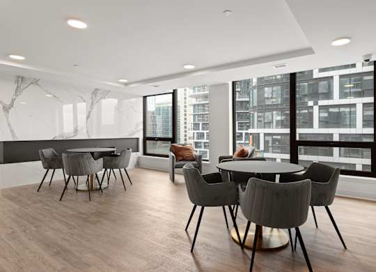 A modern dining room with a large table and chairs.