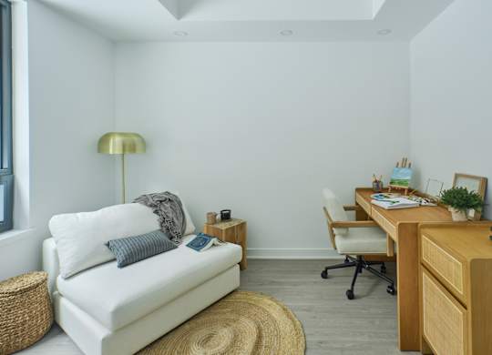 a living room with a couch and a desk