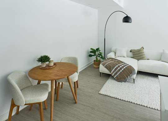 a living room with a white couch and a wooden table