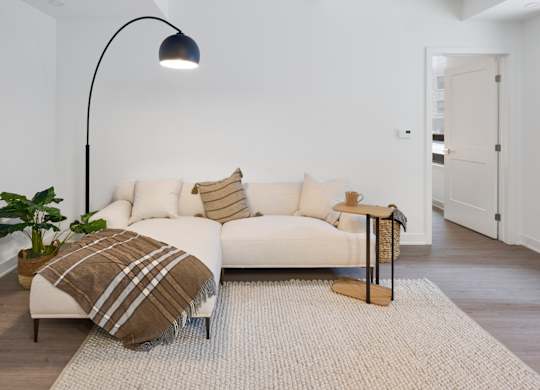 a living room with a couch and a lamp