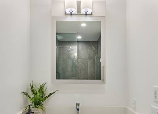 a white bathroom with a sink and a mirror
