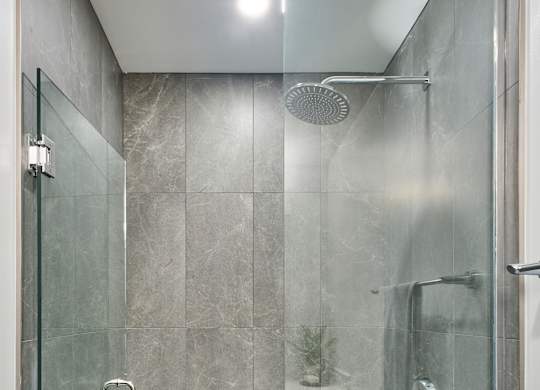 a shower with a glass door in a bathroom