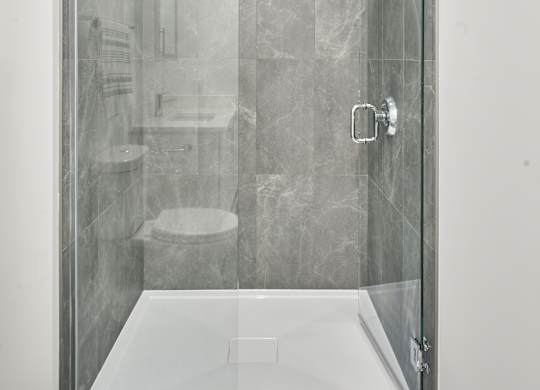 a shower with a glass door in a bathroom