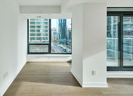 a living room with a large window and a view of the city
