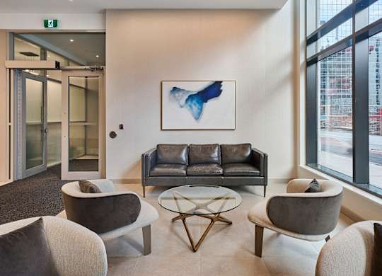 a living room with couches and chairs and a table