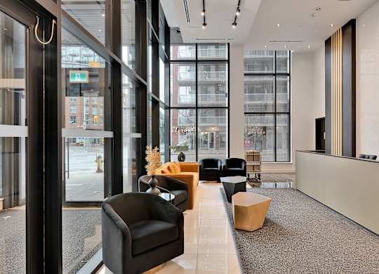 A modern waiting area with black and brown furniture.