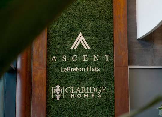 A green wall with a sign that says Ascent Le Breton Flats.
