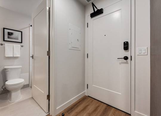 A white door with a black handle and a black lock.