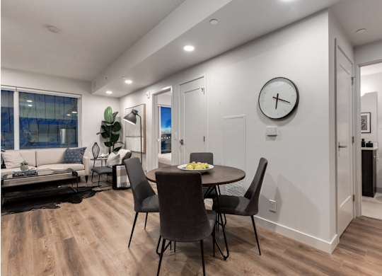 A modern dining room with a round table and chairs.