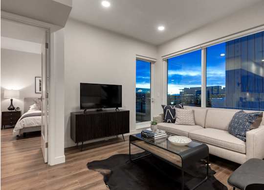 A modern living room with a large window overlooking the city.