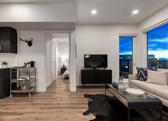 A modern living room with a large window overlooking the city.