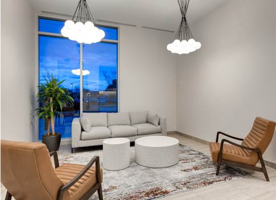 A living room with a couch, chair, and table.