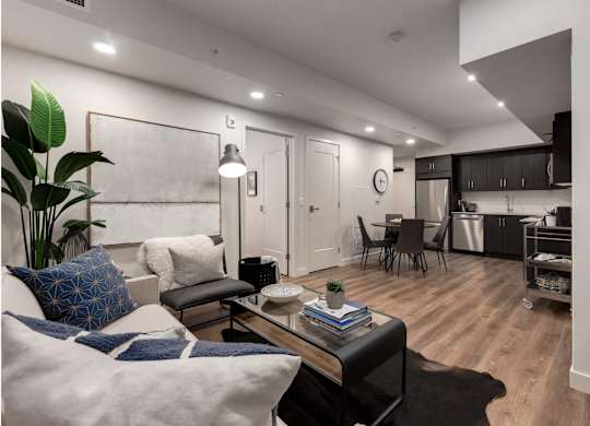 A modern living room with a white couch and a coffee table.