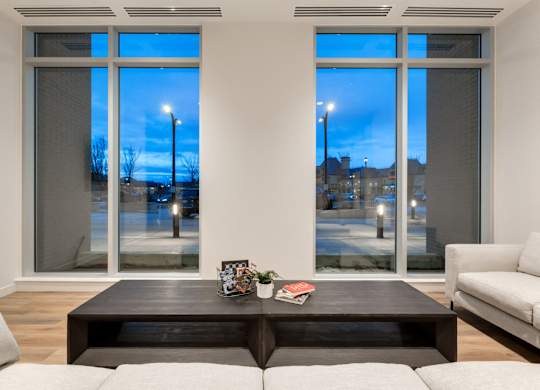 A living room with a large window and a coffee table.