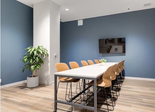 A conference room with a long table and chairs.