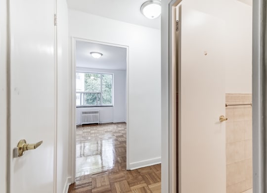 a living room with a window and a door to a bedroom
