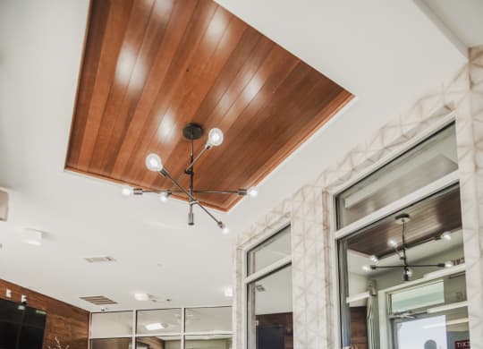 the lobby of a condo with glass doors and furniture at Canalside, Augusta, GA