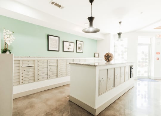 the lobby of a condo with glass doors and furniture at Canalside, Augusta, GA