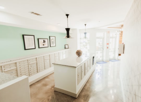 the lobby of a condo with glass doors and furniture at Canalside, Augusta, GA