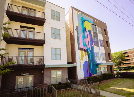 a mural on the side of an apartment building at Canalside, Augusta, GA