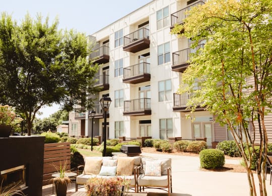 a patio with seating outside of an apartment building at Canalside, Augusta, GA