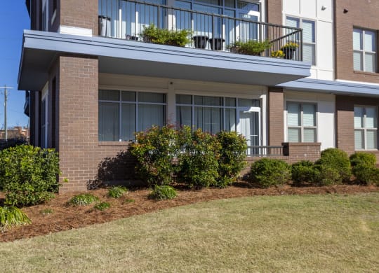 the front of a house with a yard and a balcony at Canalside, Augusta, GA