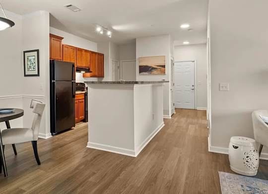 A kitchen with a dining table and chairs.