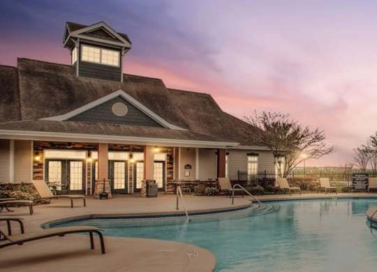 A poolside building with a tower-like structure on top.