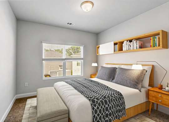 A bedroom with a large bed and a window overlooking a balcony.