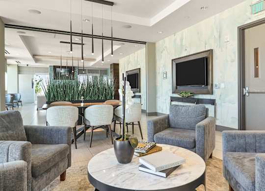 A living room with grey chairs and a white coffee table.