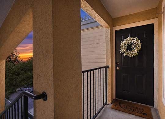 A black door with a wreath on it.