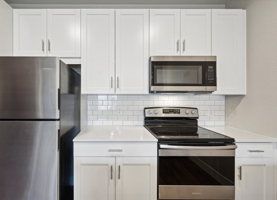 Kitchen with White Cabinetry and Stainless Steel Appliances