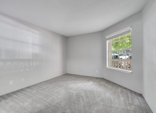 Bedroom With Large Window Overlooking The Patio