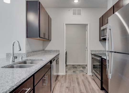 Kitchen Featuring Granite Countertops & Stainless Steel Appliances